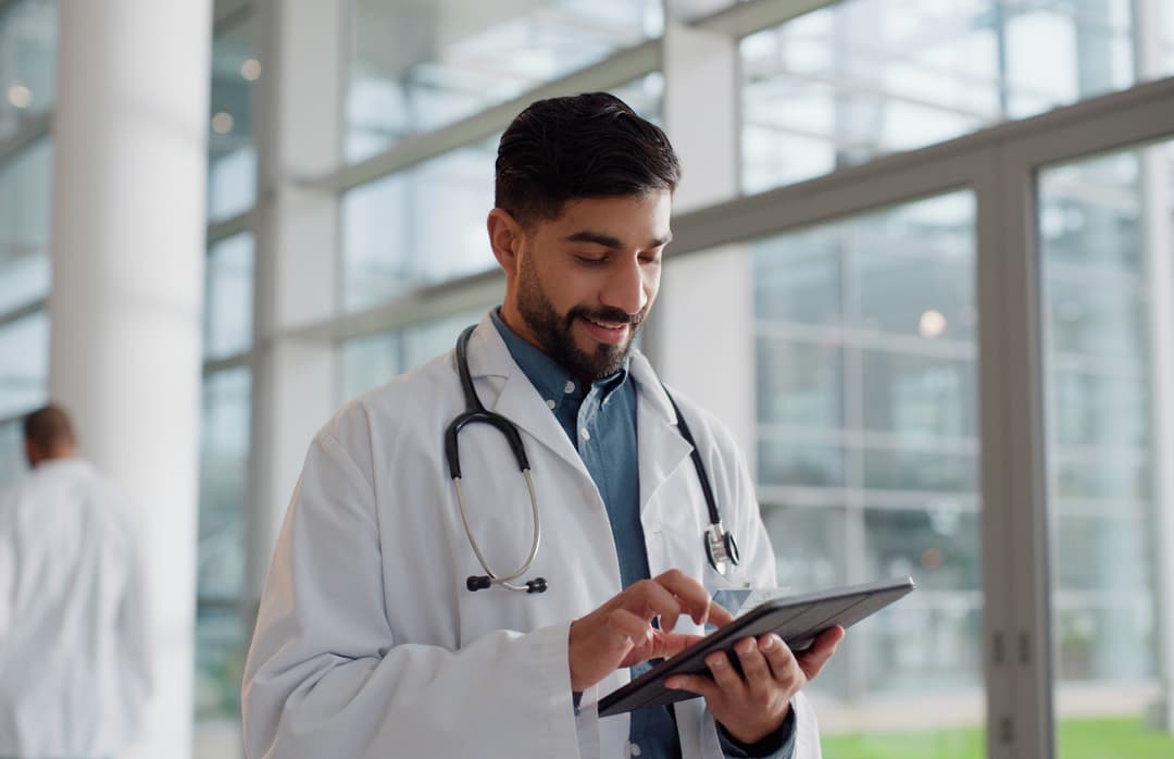 Woman looking down at tablet while working
